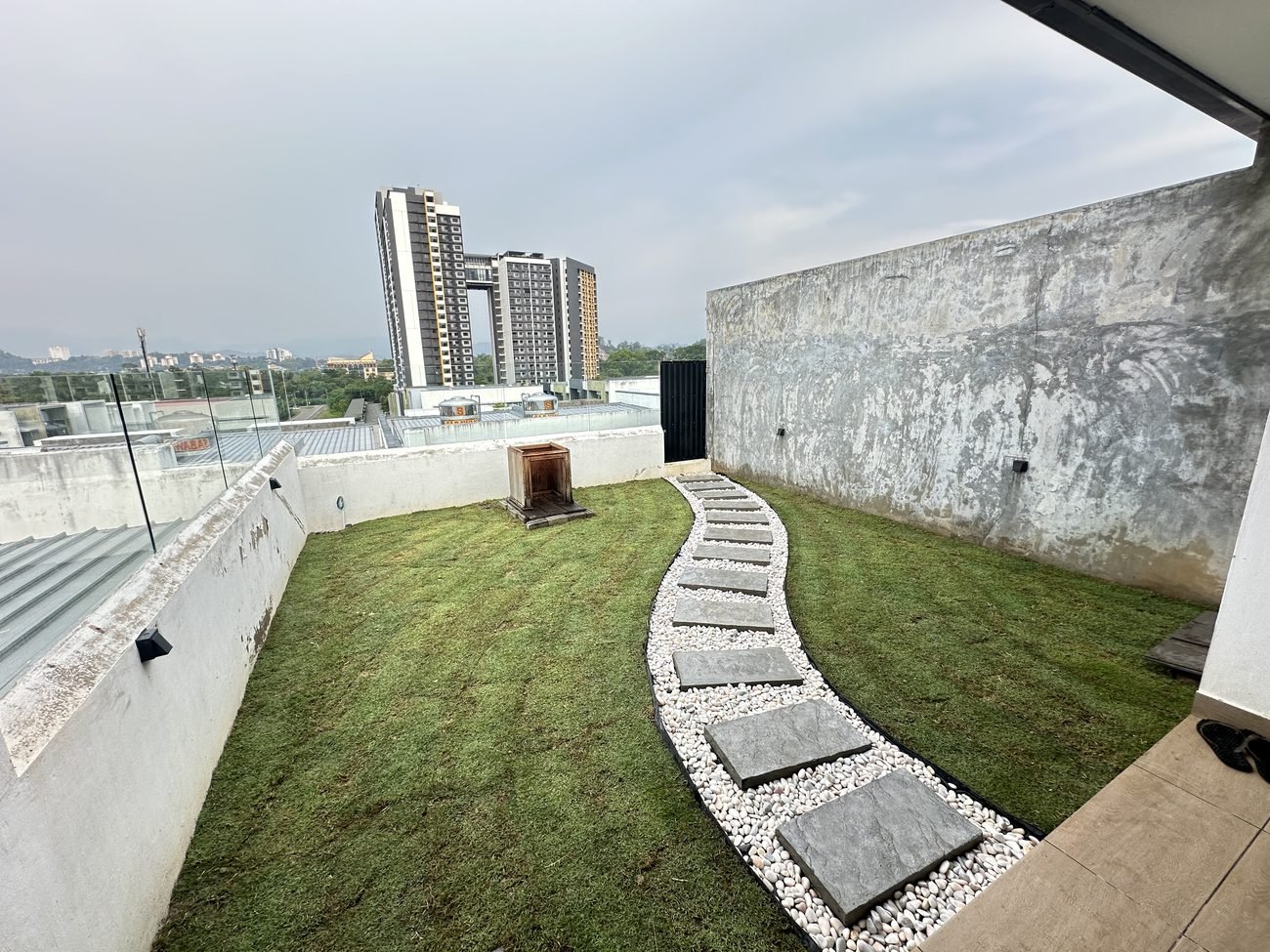 Rooftop garden lawn with stepping stone path